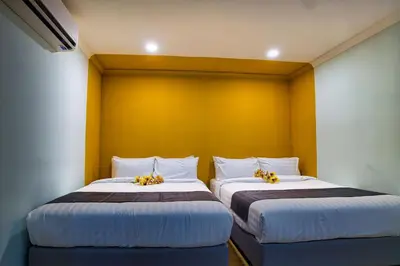 two beds sitting next to each other in a room at Alami Garden Hotel Kuala Lumpur in Kuala Lumpur