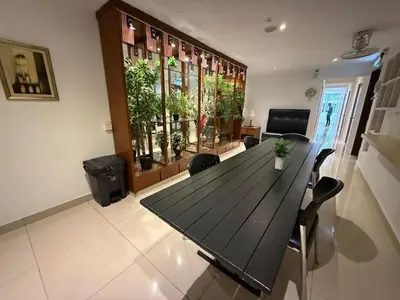 a dining room with a black table and chairs at BG Travelers Home in Kuala Lumpur