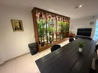 a room with a wooden table with chairs and plants at BG Travelers Home in Kuala Lumpur