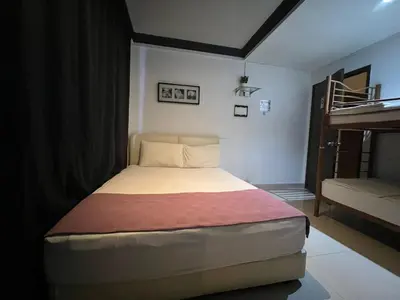 a small bedroom with a bed and a bunk bed at BG Travelers Home in Kuala Lumpur