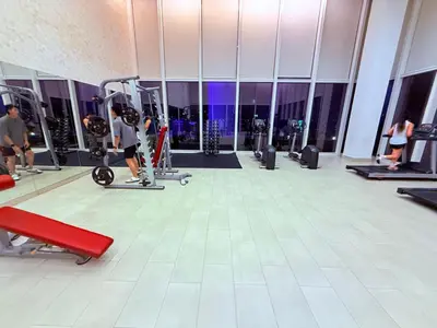 a gym with a person riding a bike in a gym at Platinum Suites in Kualalumpur City Center in Kuala Lumpur