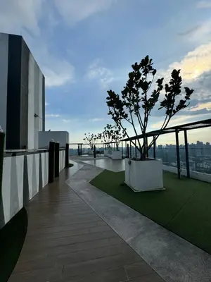 a balcony with a tree on top of a building at Rosewood Suites at Reizz Residence in Kuala Lumpur