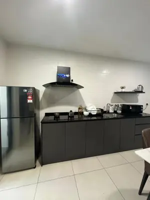 a kitchen with a refrigerator and a laptop on top of it at Rosewood Suites at Reizz Residence in Kuala Lumpur