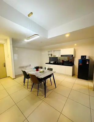 a kitchen and dining room with a table and chairs at Rosewood Suites at Reizz Residence in Kuala Lumpur