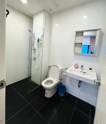 a bathroom with a shower and a toilet and a sink at Rosewood Suites at Reizz Residence in Kuala Lumpur