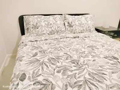 a bed with a gray and white comforter at Majestic Residence KLCC Royal Premium King Bed in Kuala Lumpur