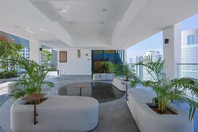 a lobby with white furniture and plants in a building at Majestic Residence KLCC Royal Premium King Bed in Kuala Lumpur