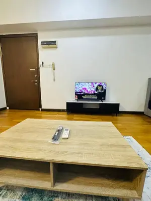 a living room with a coffee table and a tv at Regalia Apartments By FA 3 in Kuala Lumpur
