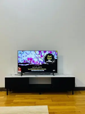 a flat screen tv sitting on top of a table at Regalia Apartments By FA 3 in Kuala Lumpur