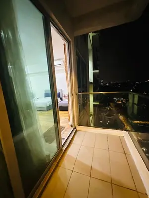 a balcony with a view of a city at night at Regalia Apartments By FA 3 in Kuala Lumpur