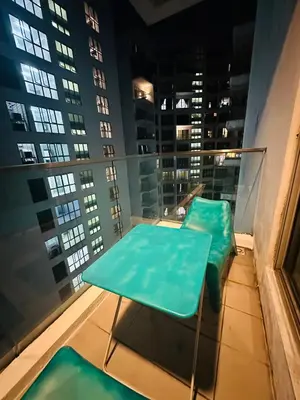a balcony with a table and chairs in a building at Regalia Apartments By FA 3 in Kuala Lumpur