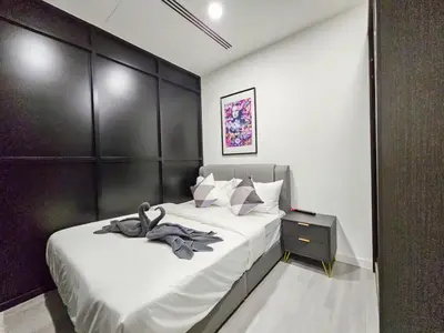 a bedroom with two beds and a black headboard at Binjai 8 Modern Suites by CityNest in Kuala Lumpur