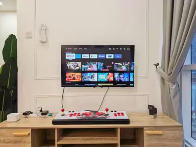 a computer sitting on a wooden table with a monitor at Binjai 8 Modern Suites by CityNest in Kuala Lumpur