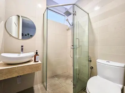 a bathroom with a toilet and a glass shower at Binjai 8 Modern Suites by CityNest in Kuala Lumpur
