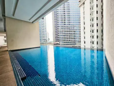 a swimming pool in a building with tall buildings at Binjai 8 Modern Suites by CityNest in Kuala Lumpur