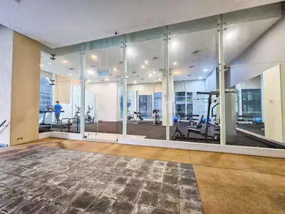 an empty room with a gym with glass walls at Binjai 8 Modern Suites by CityNest in Kuala Lumpur