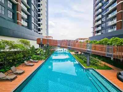 a swimming pool on a building with chairs and a building at Trion 2 KL Cityview Suites by CityNest in Kuala Lumpur