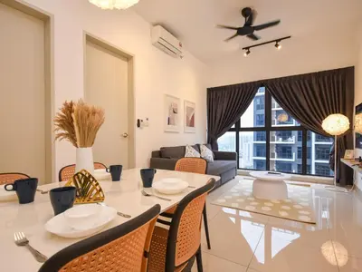 a dining room and living room with a table and chairs at Trion 2 KL Cityview Suites by CityNest in Kuala Lumpur