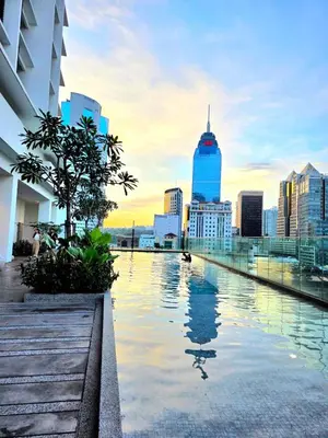 a pool on top of a building with a city skyline at Quill KLCC By Signature in Kuala Lumpur