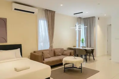 a bedroom with a bed and a couch and a table at Quill KLCC By Signature in Kuala Lumpur