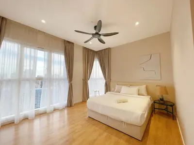 a bedroom with a bed and a ceiling fan at Quill KLCC By Signature in Kuala Lumpur