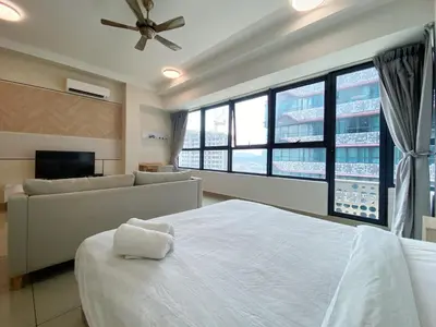 a bedroom with a large bed and a couch at Arte Plus Ampang Free Parking By Paradgm Stay in Batu Empat
