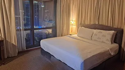 a bedroom with a bed with a view of a city at BT Apartment times square kl in Kuala Lumpur