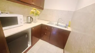 a small kitchen with a sink and a microwave at BT Apartment times square kl in Kuala Lumpur