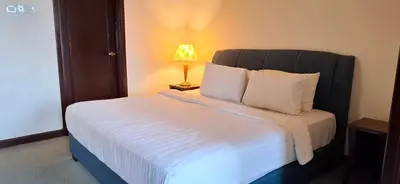 a bedroom with a large bed with a lamp on it at BT Apartment times square kl in Kuala Lumpur