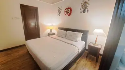 a bedroom with a bed and two lamps on tables at BT Apartment times square kl in Kuala Lumpur