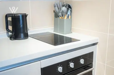 a kitchen counter with a coffee pot and utensils at 2BR Minimalist Urban Retreat at Trion KL in Kuala Lumpur