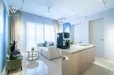 a kitchen and living room with a couch and a tv at 2BR Minimalist Urban Retreat at Trion KL in Kuala Lumpur