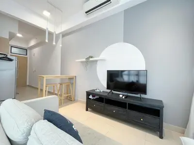 a living room with a couch and a flat screen tv at The Colony By Infinitum By Paradgm Stay in Kuala Lumpur
