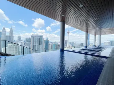 a swimming pool on the top of a building with a city skyline at The Colony By Infinitum By Paradgm Stay in Kuala Lumpur