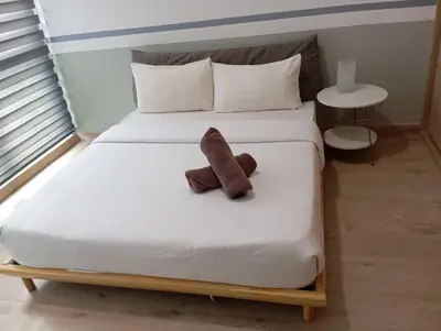 a stuffed teddy bear sitting on a bed at The Colony Infinitum By Paradgm Nest Stay in Kuala Lumpur