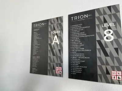 two signs hanging on a wall with the words tuition andoser at Trion KL By Paradgm Nest Stay Free Parking in Kuala Lumpur
