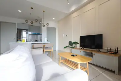 a living room with a bed and a tv and a table at Trion KL By Paradgm Stay With Balcony in Kuala Lumpur