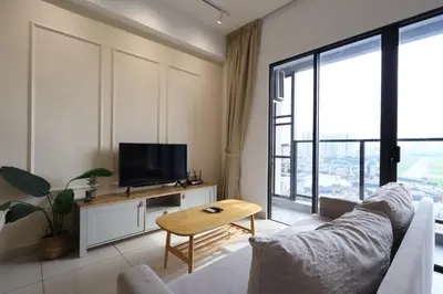 a living room with a couch and a tv at Trion KL By Paradgm Stay With Balcony in Kuala Lumpur