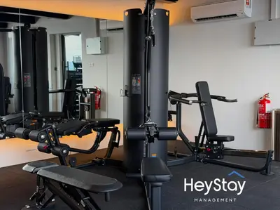 a gym with several tread machines in a room at Isola KLCC by HeyStay Management in Kuala Lumpur