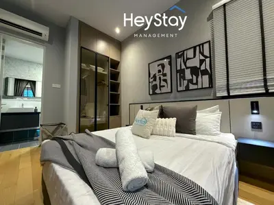 a bedroom with a large white bed with pillows at Isola KLCC by HeyStay Management in Kuala Lumpur