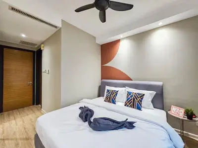 a bedroom with a large white bed with a ceiling fan at Casa Residency Family CityView Suites by CityNest in Kuala Lumpur