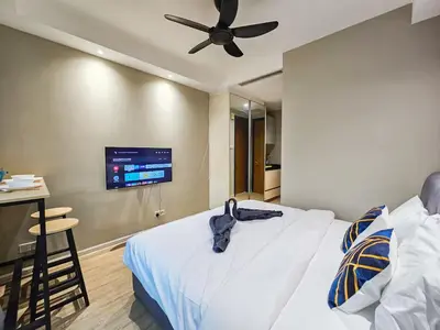 a bedroom with a bed with a ceiling fan at Casa Residency Family CityView Suites by CityNest in Kuala Lumpur