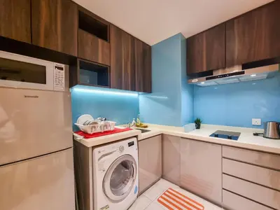 a kitchen with a washer and a washing machine at KL City Designer Studio in D Majestic near LRT and Lalaport CityNest in Kuala Lumpur