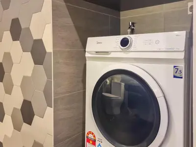 a white washing machine in a bathroom next to a wall at KL City Designer Studio in Ceylonz with KL118 Tower View CityNest in Kuala Lumpur