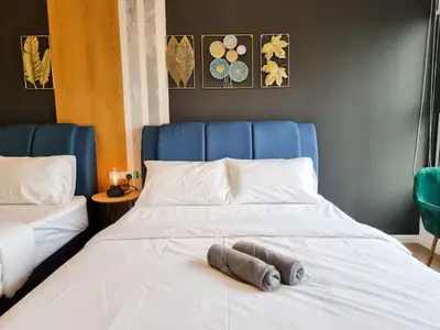 a large white bed with a blue head board at KL City Designer Studio in Ceylonz with KL118 Tower View CityNest in Kuala Lumpur