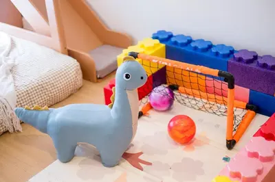 a childs bedroom with a toy dinosaur and toys at Bright 3BR Kids Café Home Slide LEGO Playroom in Kuala Lumpur