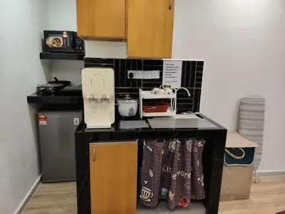 a kitchen with a counter top with a stove top at Fahrenheit 88 Suites, Bukit Bintang 4R in Kuala Lumpur