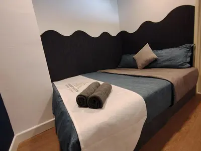 a bed with two towels on top of it at Fahrenheit 88 Suites, Bukit Bintang 4R in Kuala Lumpur