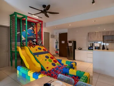 a kitchen with a play room with a slide at One Residences Family Suites KL by CityNest in Kuala Lumpur