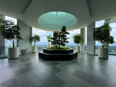 a room with trees in a building with windows at The Atrium Jalan Ampang Elegant Fully Air-Con 3 BR Homestay in Kuala Lumpur